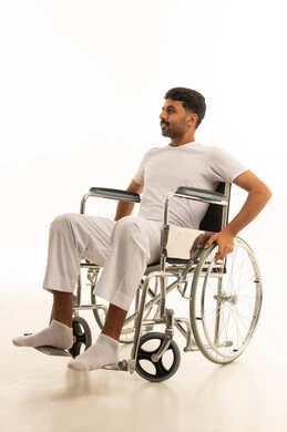 Saudi Man in Manual Wheelchair on White Background