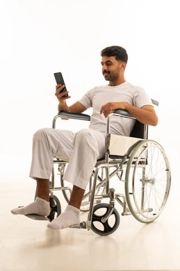 Saudi Man in Wheelchair Using Smartphone