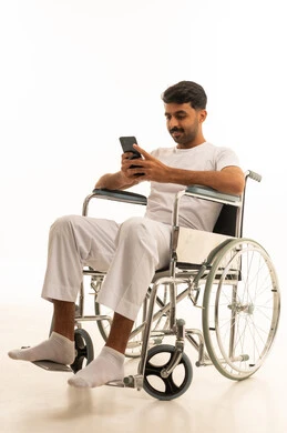 Saudi Man in Wheelchair Using Smartphone in Studio