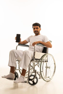 Saudi Man in Wheelchair Holding Smartphone White Background