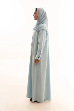 Emirati Woman in Blue Abaya Standing in Profile