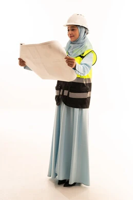 Arab Female Engineer Reading Blueprint in Studio