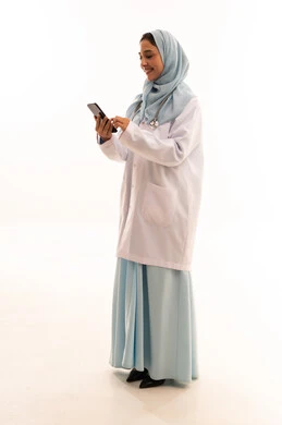 Saudi Female Doctor Using Smartphone in Lab Coat