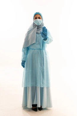 Arab Medical Worker in Blue PPE Making Stop Gesture