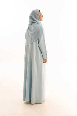Emirati Woman in Light Blue Abaya on White Background