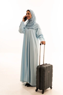 Arab Woman in Blue Abaya with Travel Suitcase
