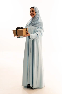 Emirati Woman in Blue Abaya Holding Gift Box