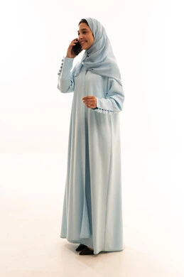 Saudi Woman in Blue Abaya Talking on Smartphone