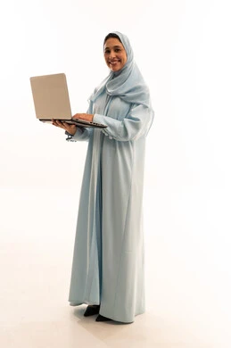 Saudi Woman in Blue Abaya Using Laptop in Studio