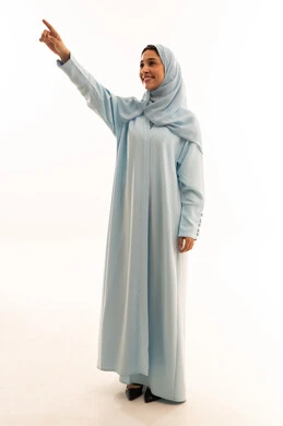 Emirati Woman in Light Blue Abaya Pointing Upward