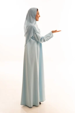 Emirati Woman in Blue Abaya Presenting on White Background
