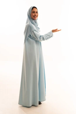Saudi Woman in Blue Abaya Gesturing on White Background Saudi Woman in Blue Abaya Gesturing on White Background