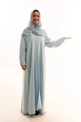 Saudi Woman in Blue Abaya Presenting on White Background