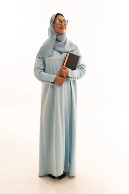 Saudi Woman in Light Blue Abaya Holding a Book in Studio