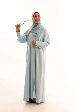 Arab Woman in Blue Abaya Holding Glasses Studio Shot