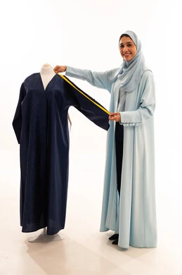 Saudi Female Fashion Designer Measuring Navy Blue Abaya