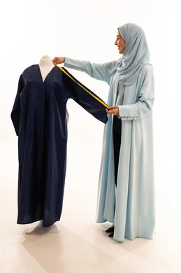 Emirati Fashion Designer Measuring Abaya in Studio