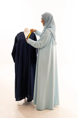 Saudi Woman Tailor Measuring Abaya in Studio