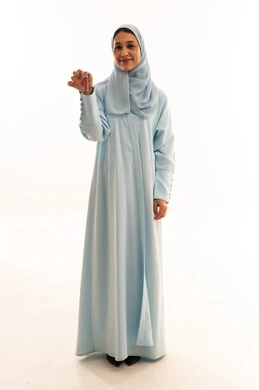 Asian Woman in Blue Abaya Holding Lipstick on White