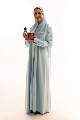 Saudi Woman Holding Makeup Palette in Studio