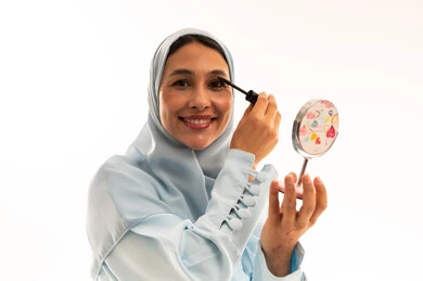 Saudi Woman in Hijab Applying Mascara in Studio