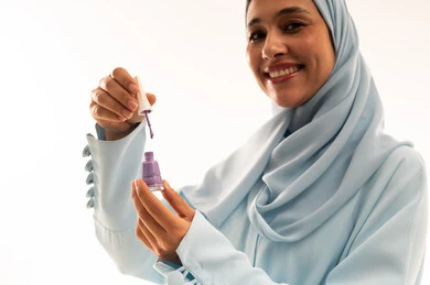 Arab Woman in Hijab Holding Purple Nail Polish Studio