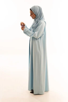 Emirati Woman in Blue Abaya with Perfume Bottle