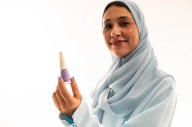 Arab Woman in Hijab Holding Purple Nail Polish Studio