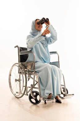 Arab Woman in Wheelchair Using Binoculars