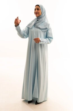 Saudi Woman in Blue Abaya Holding Perfume Bottle Saudi Woman in Blue Abaya Holding Perfume Bottle