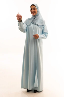 Saudi Woman in Blue Abaya Holding Perfume Bottle