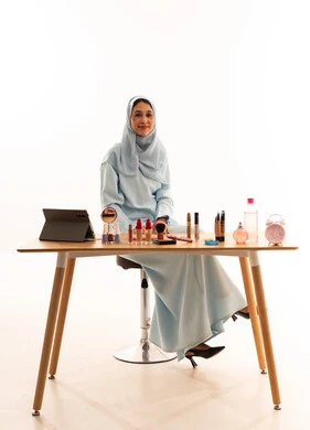 Malay Woman with Makeup Products at Studio Desk