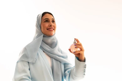 Arab Woman in Hijab Holding Perfume Bottle
