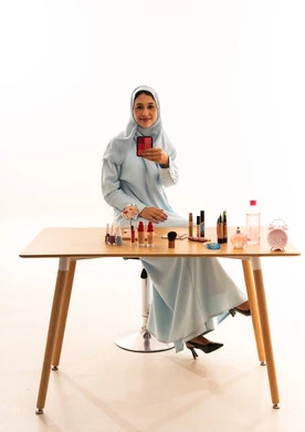 Saudi Woman Makeup Artist with Cosmetics in White Studio