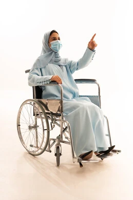 Emirati Woman in Wheelchair Wearing Abaya and Mask Emirati Woman in Wheelchair Wearing Abaya and Mask
