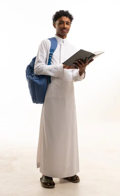 طالب سوداني بالثوب الأبيض يحمل كتاباً
