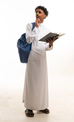 Saudi Student in Traditional White Thobe Holding Book