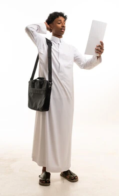 Saudi Man in White Thobe Holding Paper on White Background