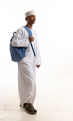 Omani Man in Traditional Dishdasha Walking with Backpack