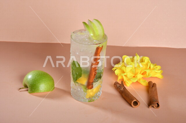 Close-up of mojito juice with fresh fruit pieces and cinnamon illustrated on a colorful background Fresh and delicious drinks Cold drinks delicious natural juices Healthy and useful juices Refreshing and iced summer cocktail citrus