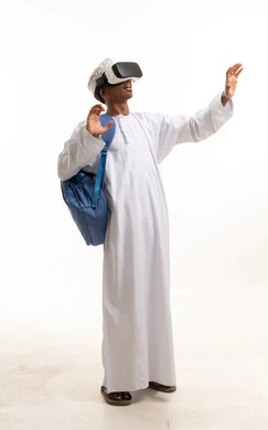 Omani Man Using VR Headset in Traditional Dress