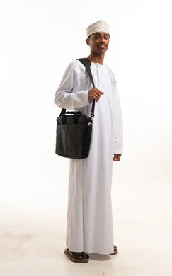 Omani Man in Traditional White Dishdasha with Laptop Bag
