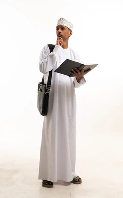Omani Student Holding Book in Traditional Dishdasha