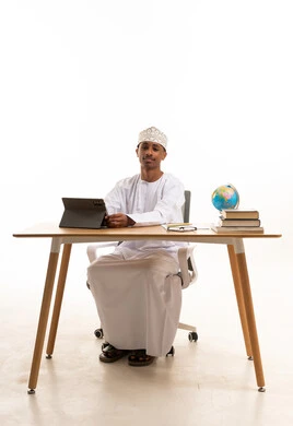 Omani Man with Tablet at Office Desk Studio