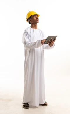 Omani Engineer in Safety Helmet Using Digital Tablet