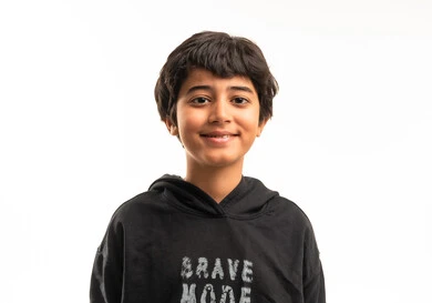 Smiling Saudi Boy in Black Hoodie Studio Portrait