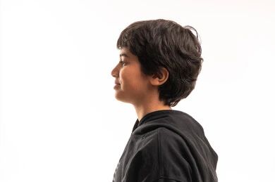 Side Profile of Saudi Boy in Black Hoodie White Background