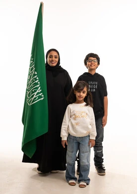 Saudi Family with National Flag on White Background