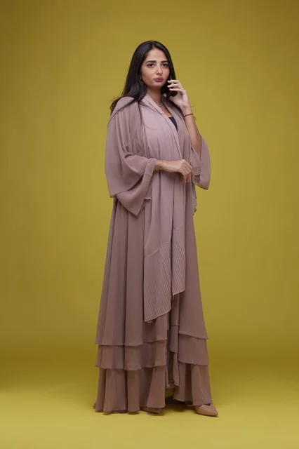 Saudi Woman in Beige Abaya Talking on Smartphone Studio
