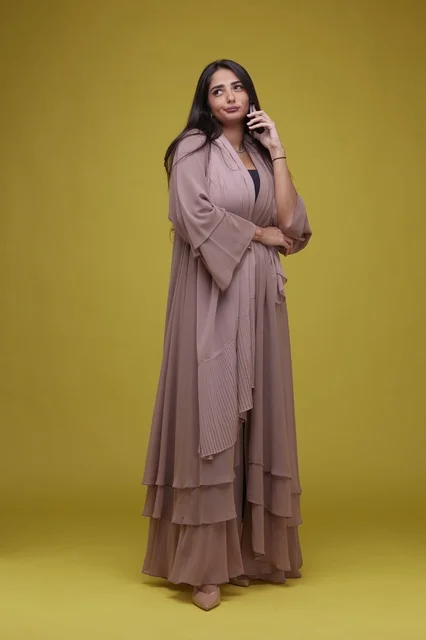 Saudi Woman in Beige Abaya on Smartphone Studio Shot